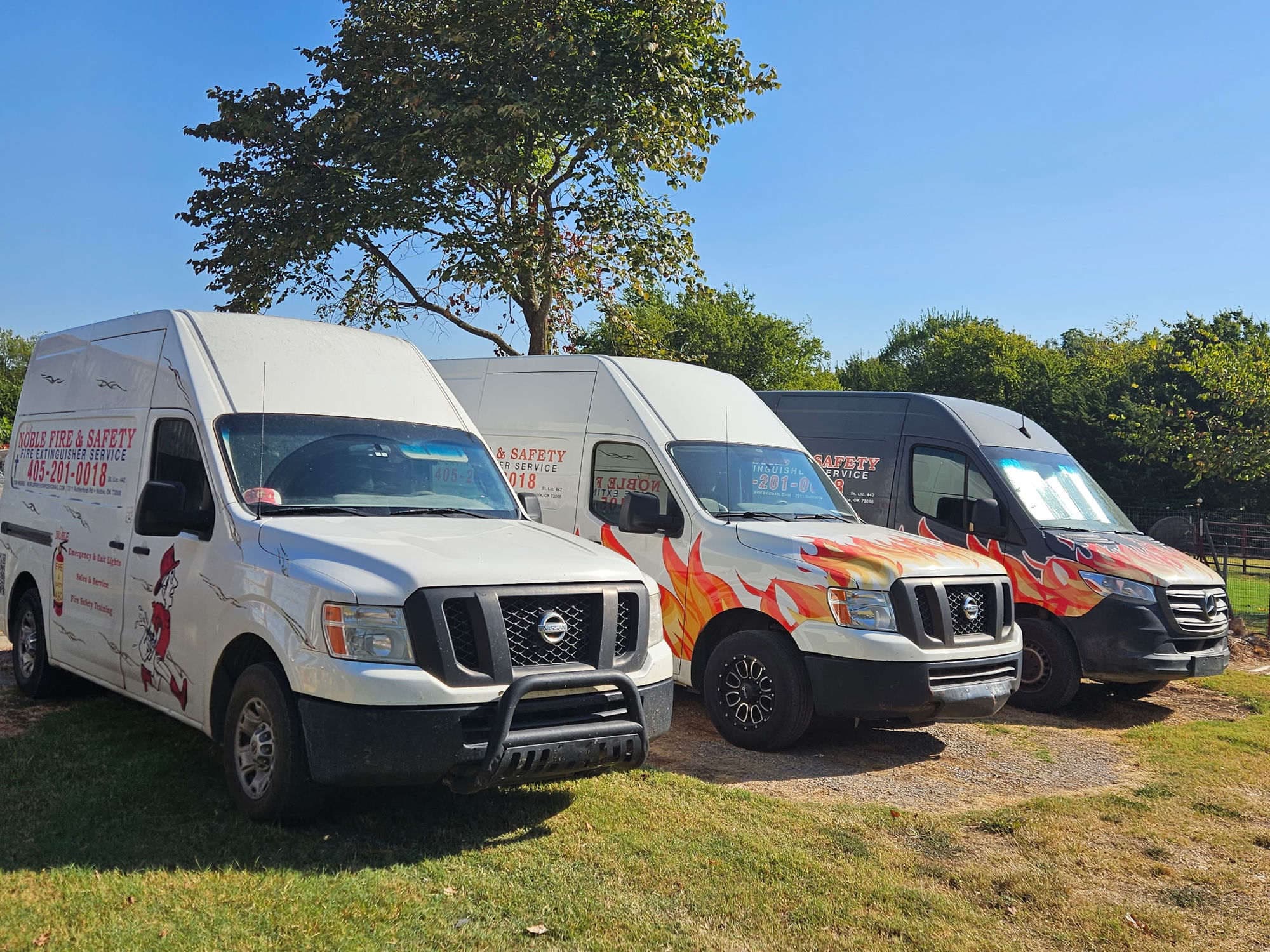 The Noble Fire & Safety service van fleet lined up at the shop in Noble, Oklahoma